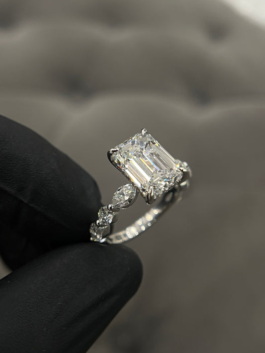 Emerald diamond set in a round/marquise band