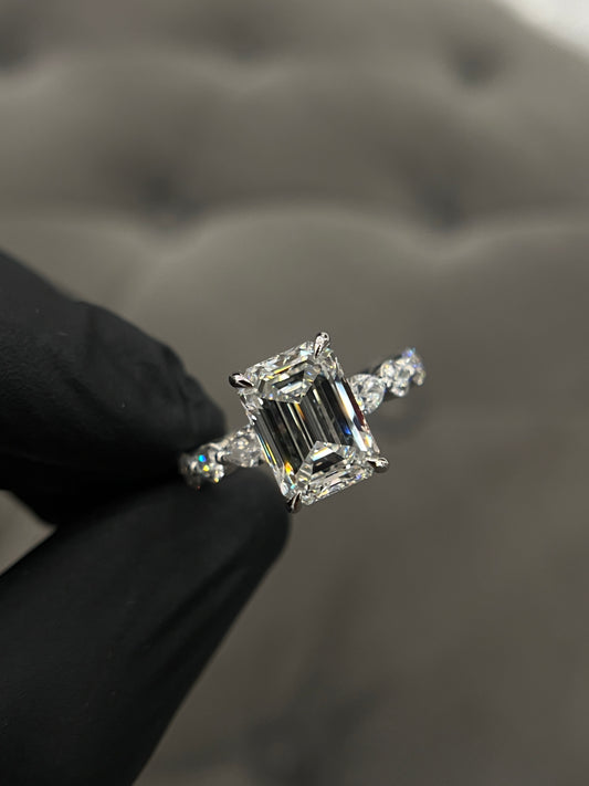 Emerald diamond set in a round/marquise band